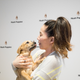 Jee Young has her photo taken with a puppy at the Hush Puppies photo booth at Mom 2.0 Summit, in Austin, Texas.